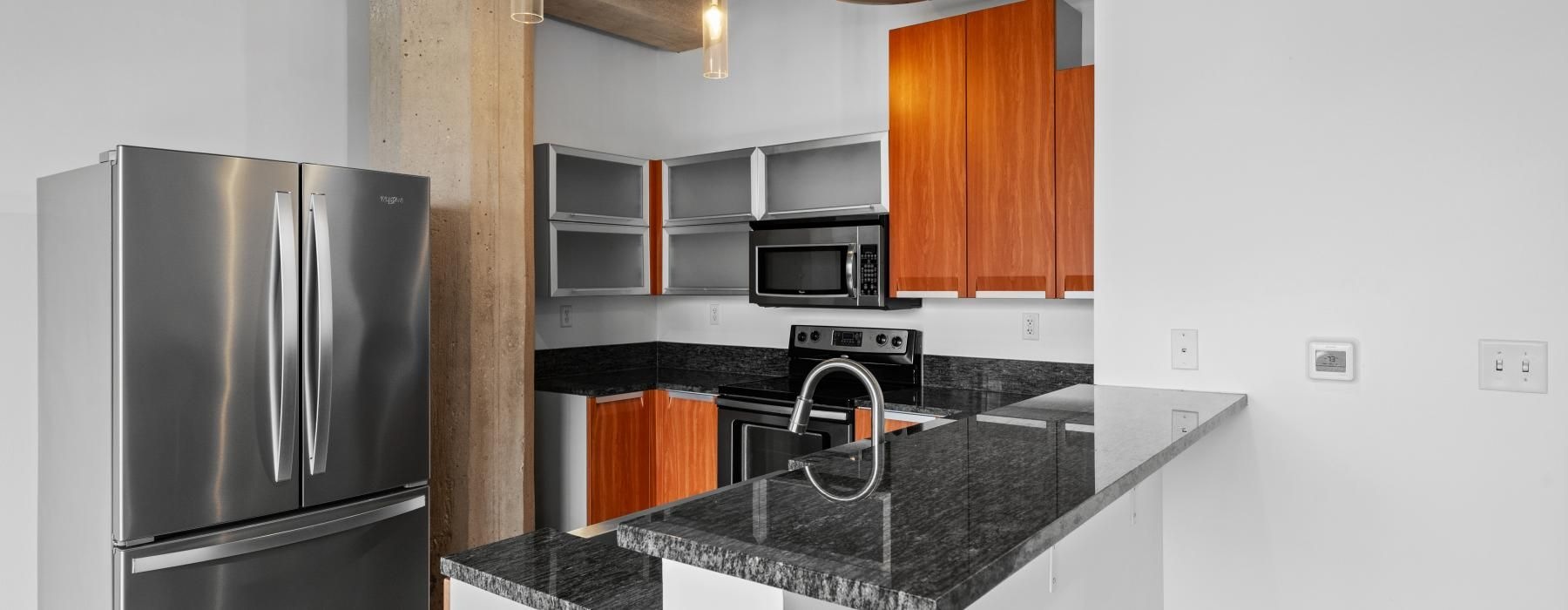 a kitchen with a stainless steel refrigerator