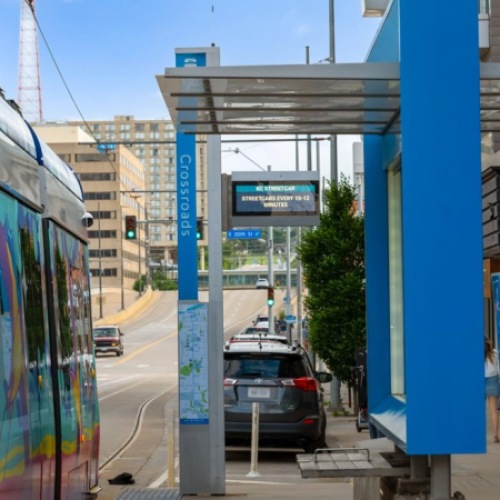 KC Streetcar stopped at the Crossroads station in downtown Kansas City with nearby sidewalk and city buildings